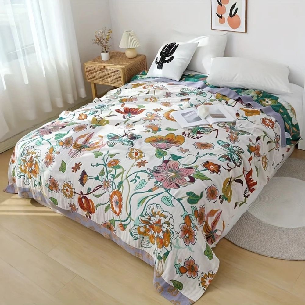 Wildflower Botanical Reverie 100% cotton blanket with a colorful floral and butterfly print.