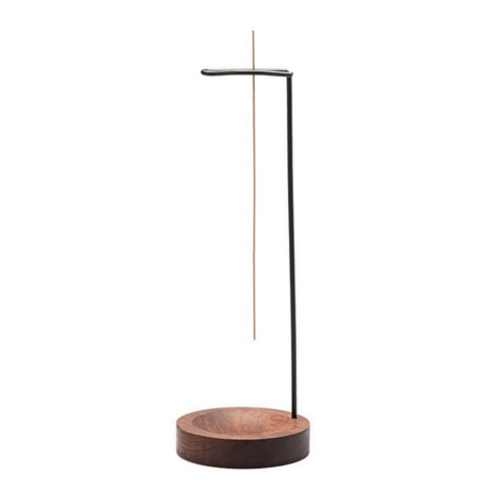 Minimalist wooden incense burner with a thin metal stand and a single incense stick.