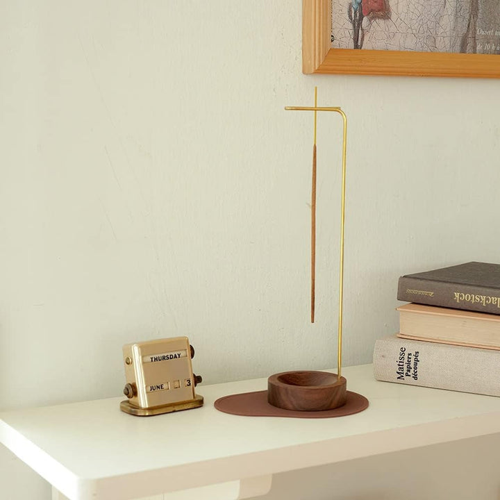 Minimalist wooden incense burner with a metal holder and an incense stick.