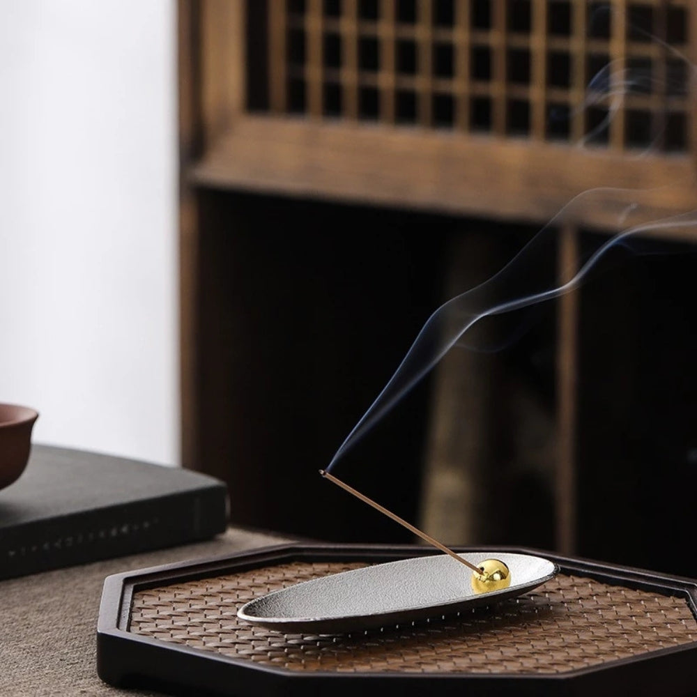 Zen Alloy Bead Incense Holder with smoke rising from an incense stick.