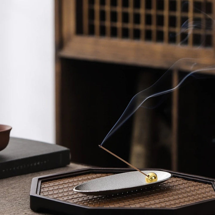 Zen Alloy Bead Incense Holder with smoke rising from an incense stick.
