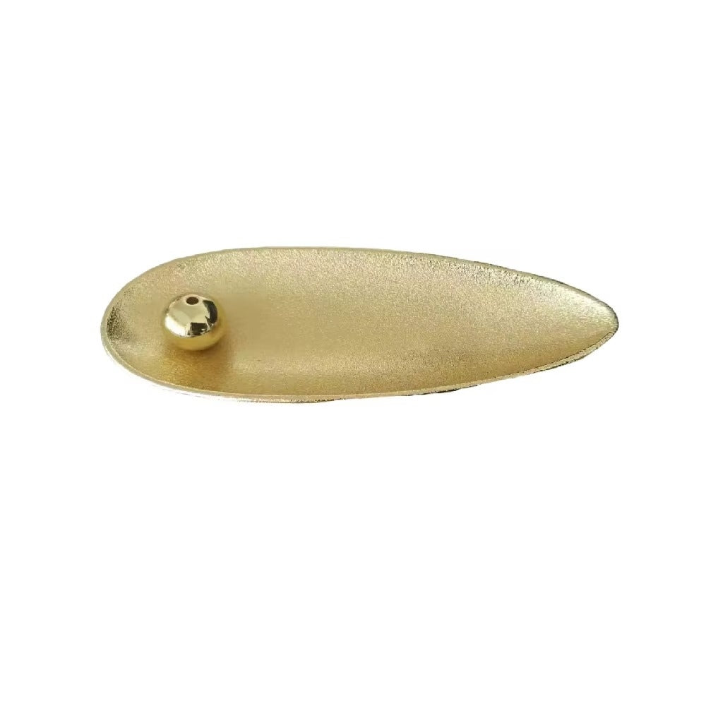 Gold alloy incense holder with a movable bead to hold incense sticks at any angle.