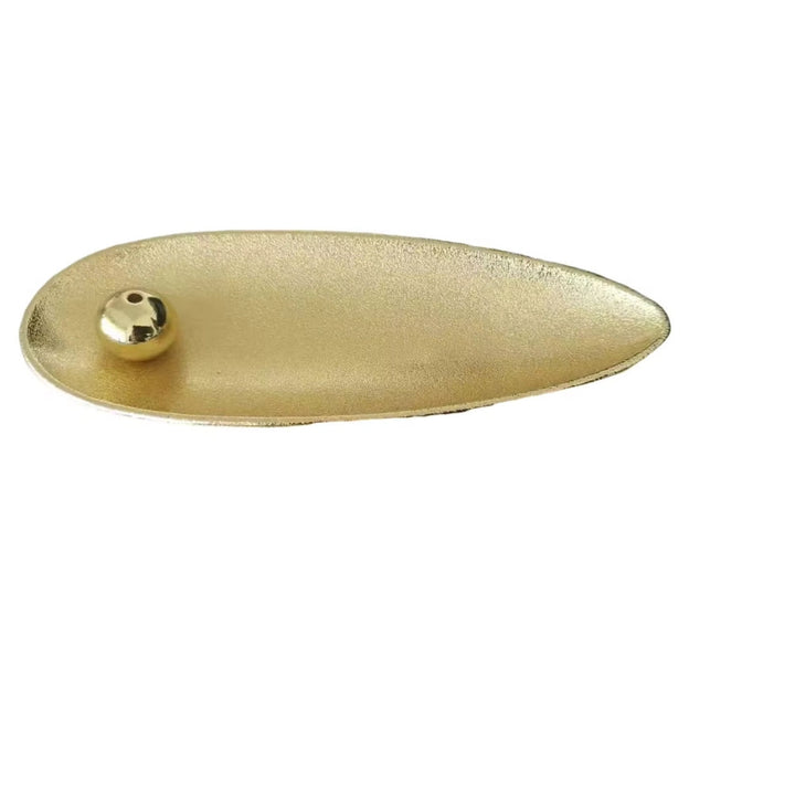 Gold teardrop-shaped incense holder with a movable gold bead to hold incense sticks.