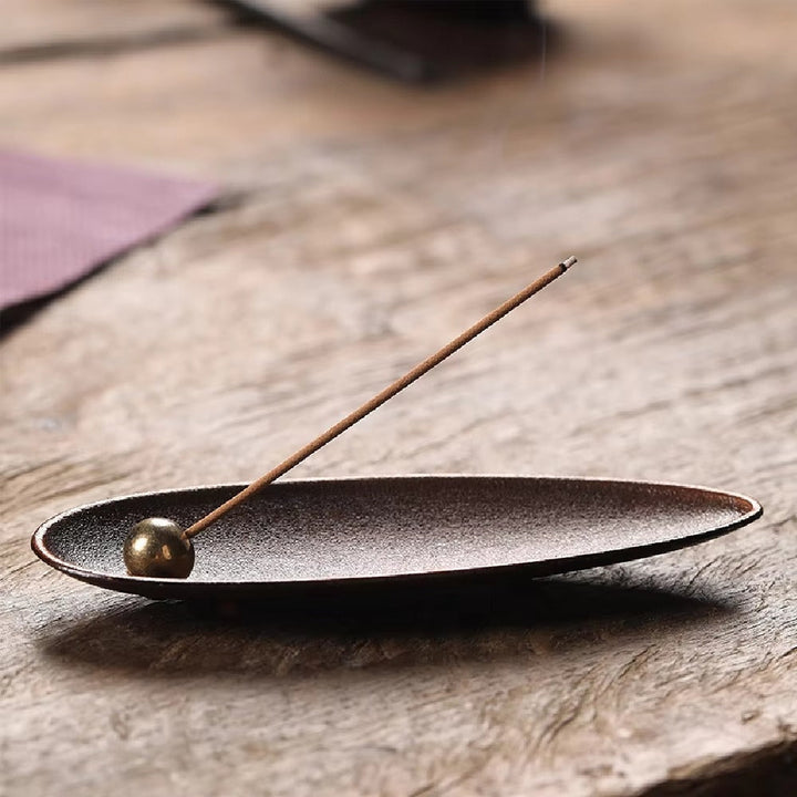 Zen Alloy Bead Incense Holder with a single incense stick burning.
