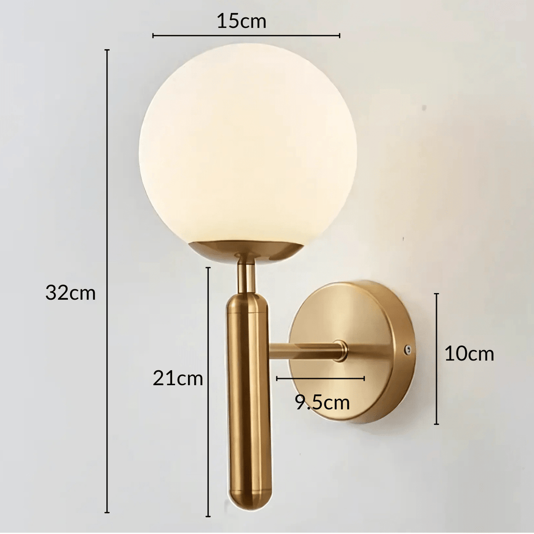 Brass wall sconce with a frosted globe light and a cylindrical arm, dimensions shown.