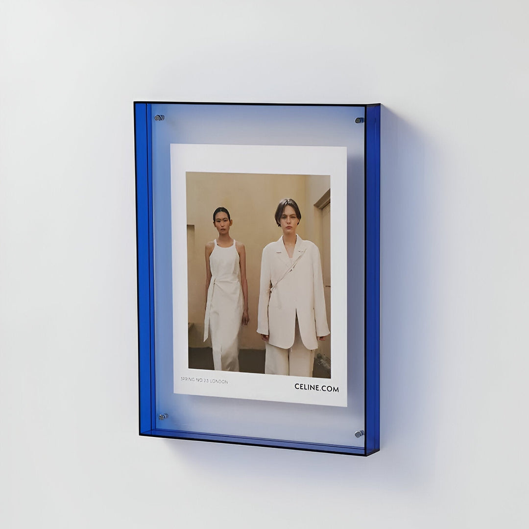 Blue acrylic picture frame displaying a fashion ad with two models.