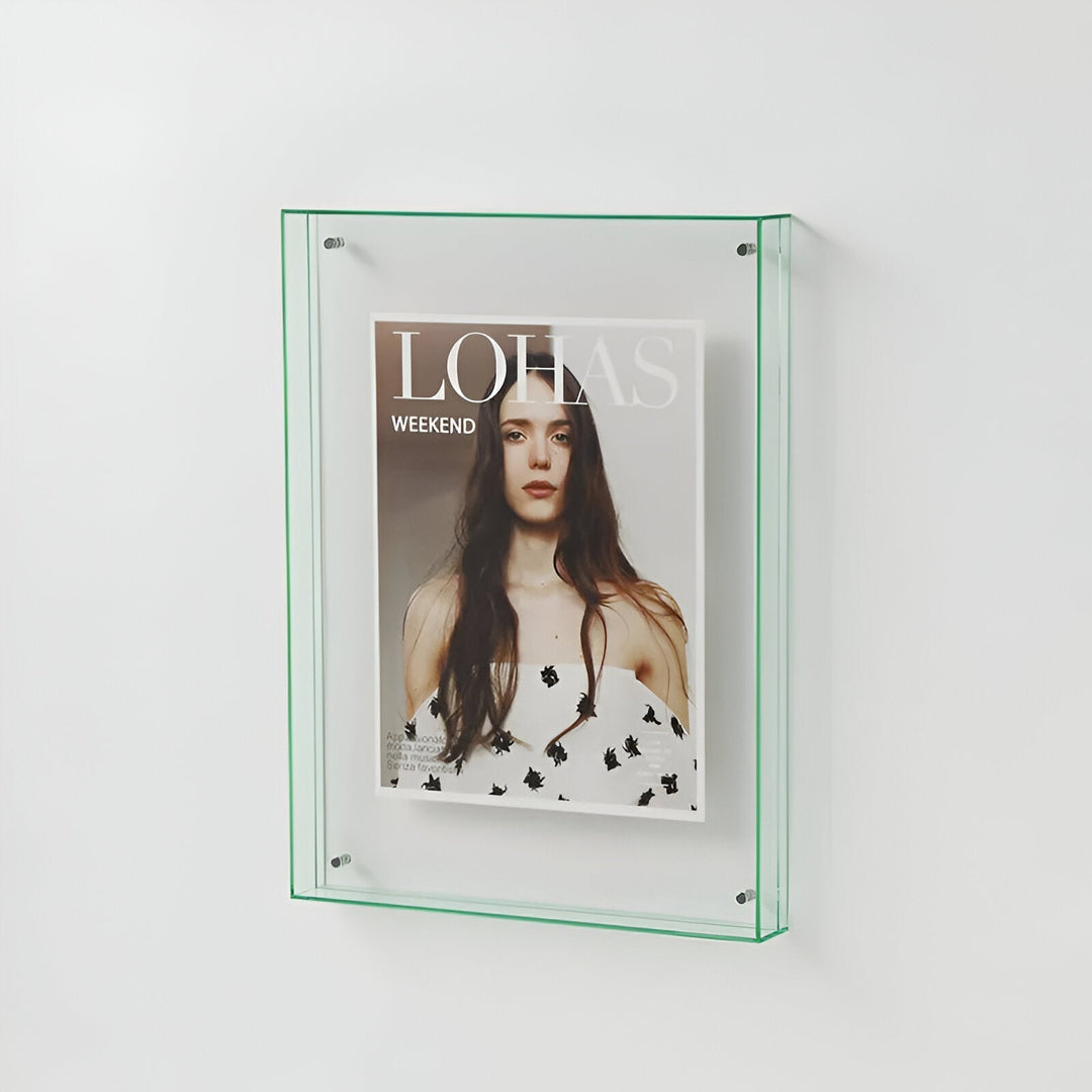 A clear acrylic picture frame with green trim, displaying a magazine cover with a woman&