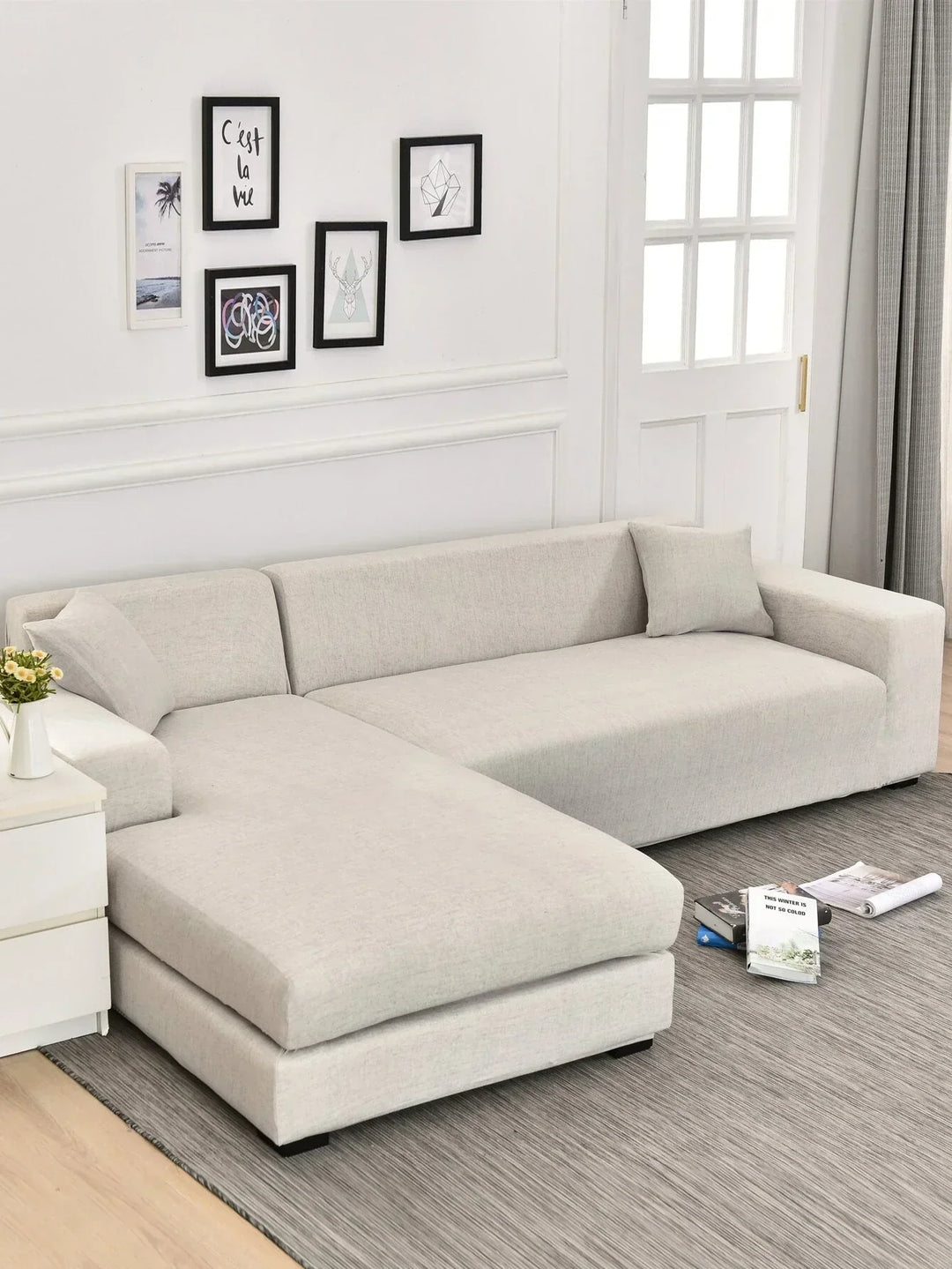 L-shaped sofa cover in eggshell cross-pattern fabric on a sectional sofa.