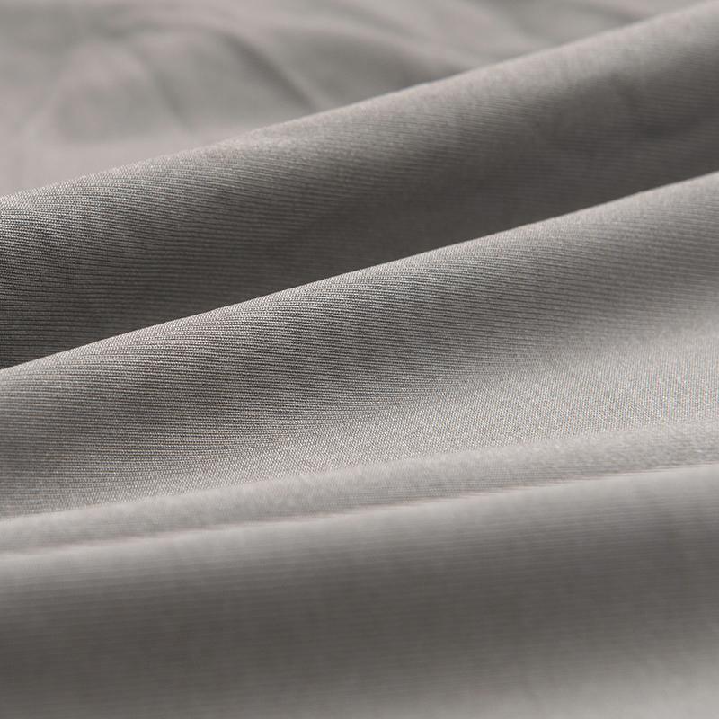 Close-up of soft, mouse grey micro-fabric sofa cover with visible texture and folds.