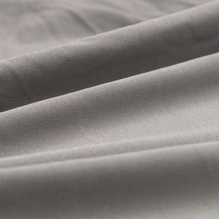 Close-up of soft, mouse grey micro-fabric sofa cover with visible texture and folds.