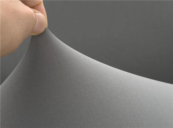 Close-up of a hand stretching soft, ribbed mouse grey micro-fabric sofa cover.
