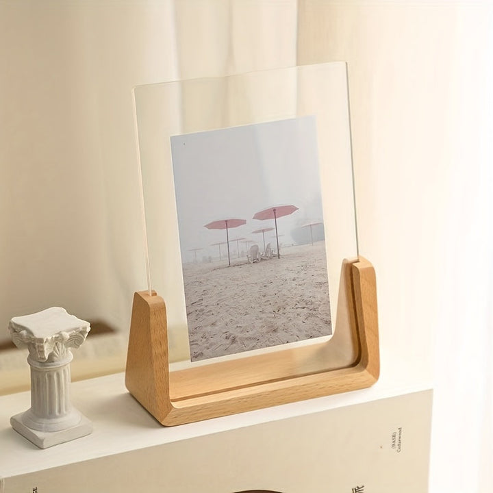 U-shaped acrylic photo frame with a wooden base displaying a beach scene with pink umbrellas.