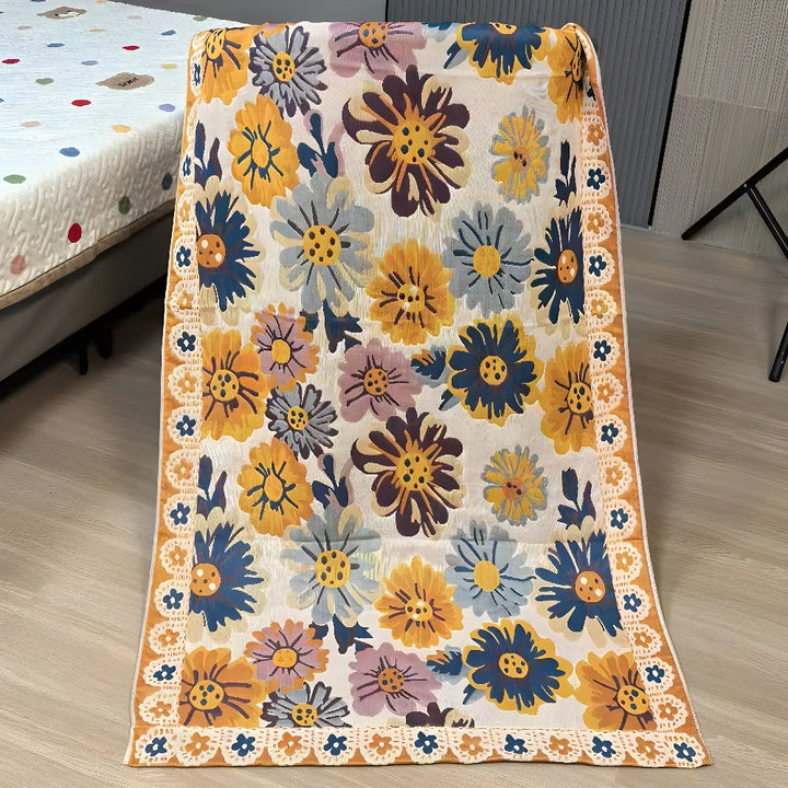 Reversible cotton bath towel with a vibrant, colorful floral print and a lace-like border.