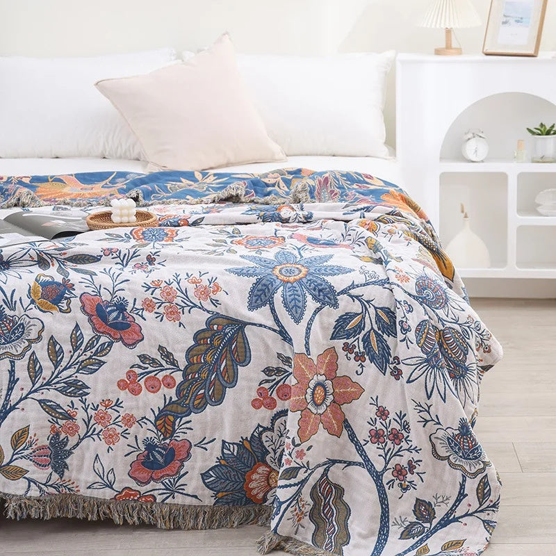 Rustic Artistic Flora Cotton Blanket with a floral pattern and fringe detail.