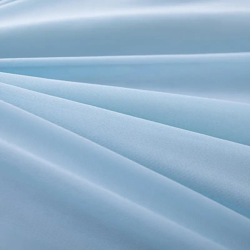 Close-up of the light blue, textured cooling fabric of the Forevercool blanket.