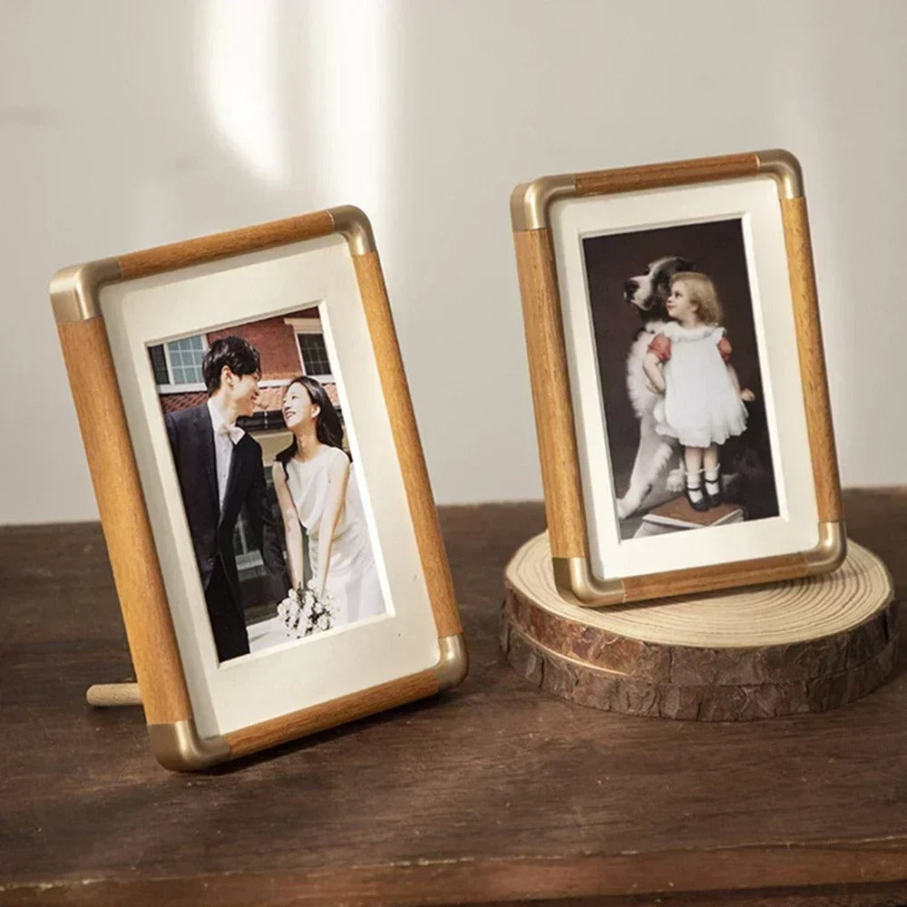 Two Brooks Vintage Photo Frames with wood and brass accents on a wooden surface.