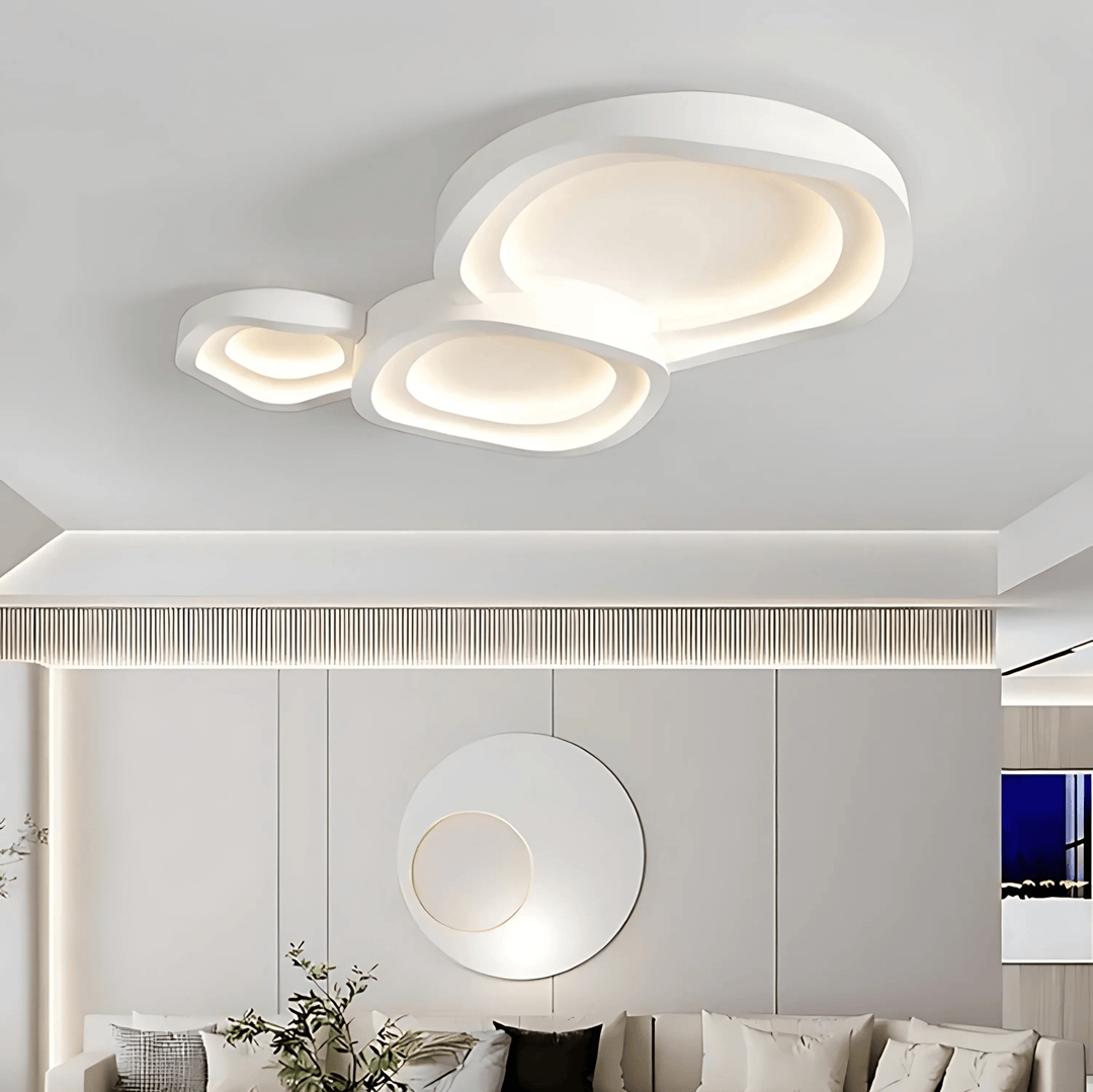 Modern white ceiling light with layered, organic shapes and integrated LED illumination.