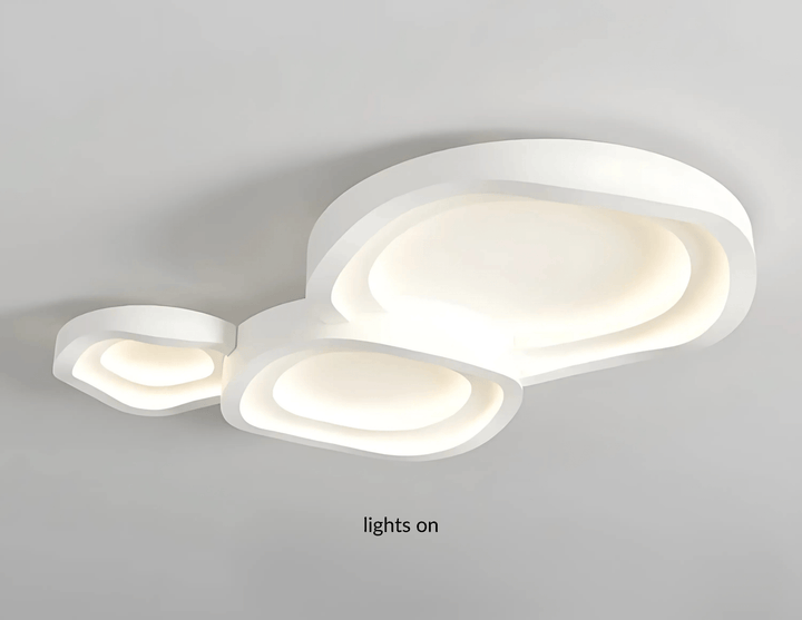 White modern ceiling light with layered, organic shapes and integrated LED illumination.