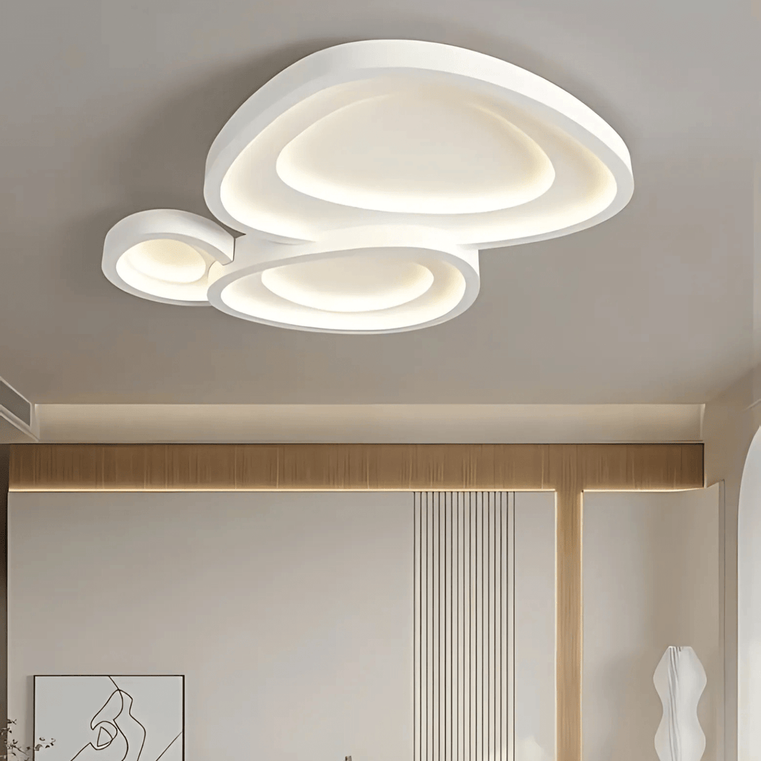 Modern white ceiling light with three overlapping abstract shapes and integrated LED illumination.