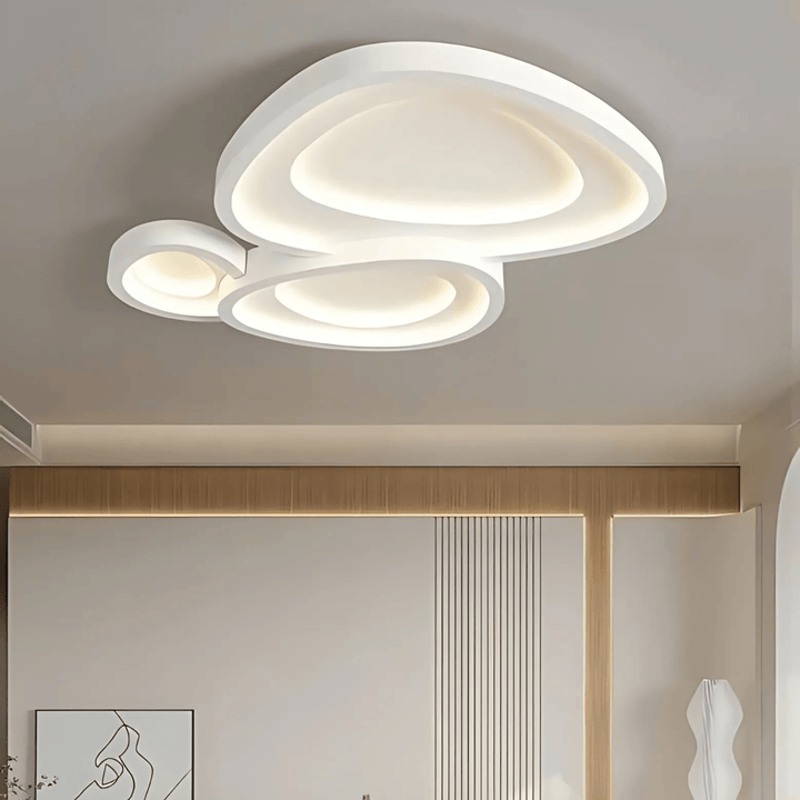 Modern white ceiling light with three overlapping abstract shapes and integrated LED illumination.