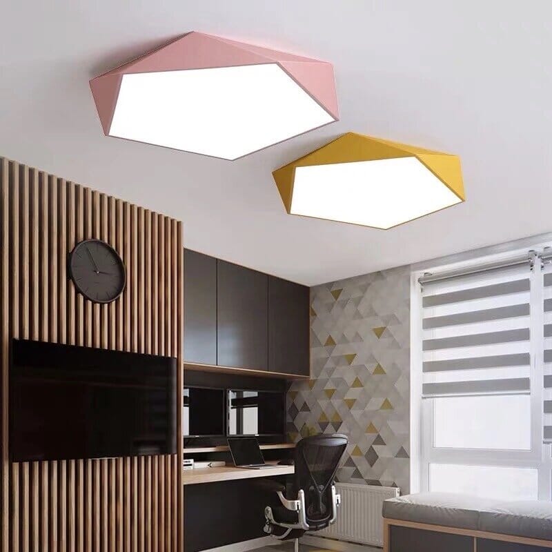 Two modern geometric dome ceiling lights, one pink and one yellow, installed on a white ceiling.