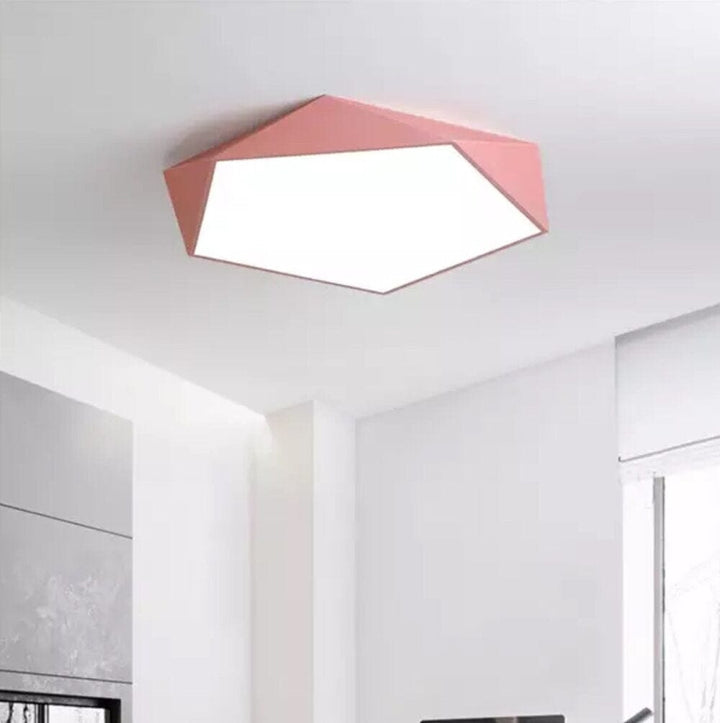 Pink geometric flush mount ceiling light with a white diffuser.