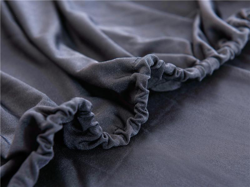 Black adaptable couch cover with elastic binding and soft micro-fabric texture.