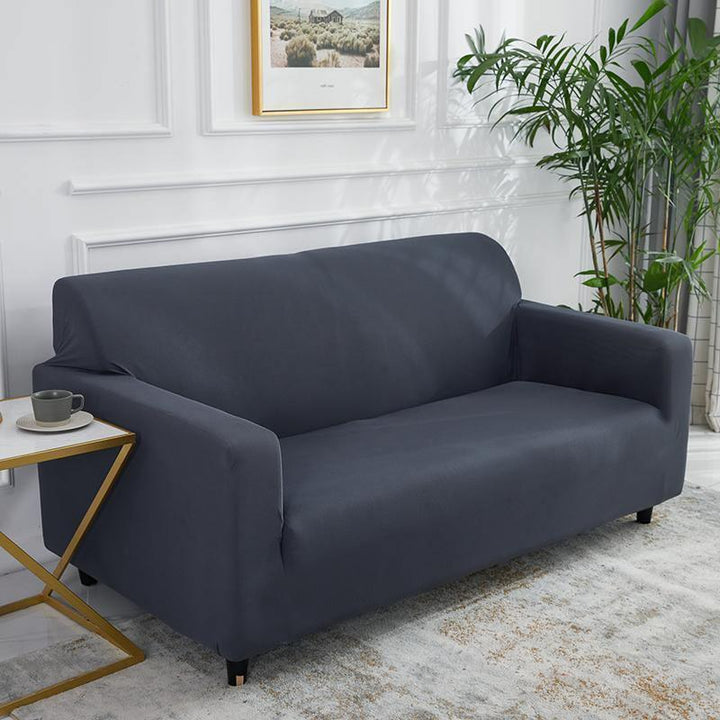 Clay grey adaptable couch cover shown on a sofa, featuring a soft micro-fabric and non-slip design.