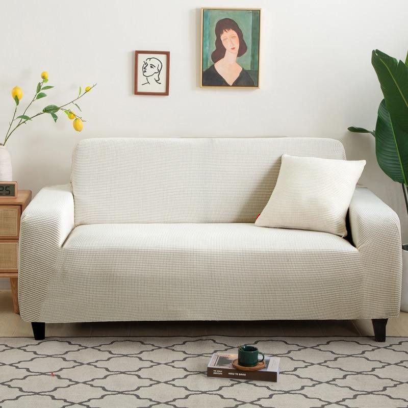 White jacquard couch cover with a subtle woven texture, shown on a sofa with a pillow.