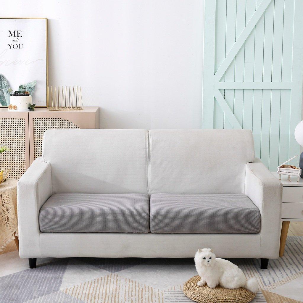 Light grey narrow jacquard sofa cushion cover with textured weave on a white sofa.
