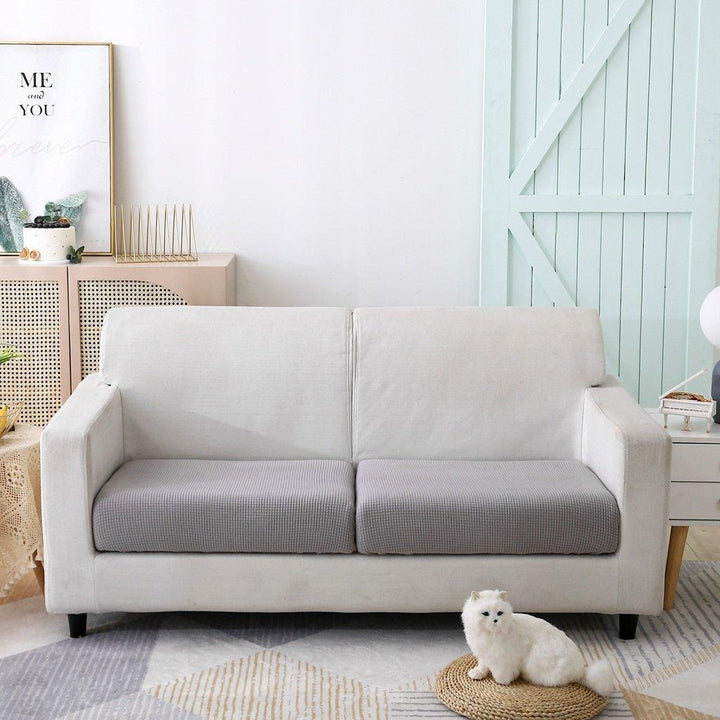Light grey narrow jacquard sofa cushion cover with textured weave on a white sofa.