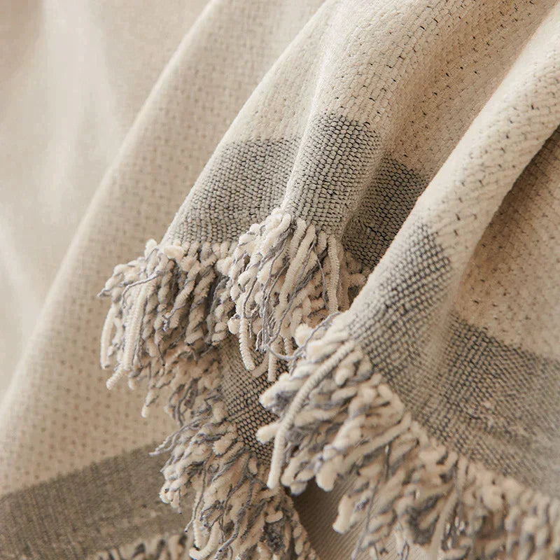 Dusty grey chenille throw blanket with soft tassels.