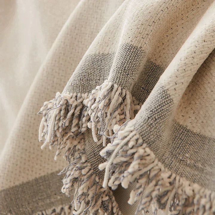Dusty grey chenille throw blanket with soft tassels.